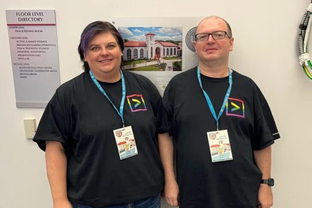 Chris and Kristy Basham wearing lanyards at WordCamp Montclair